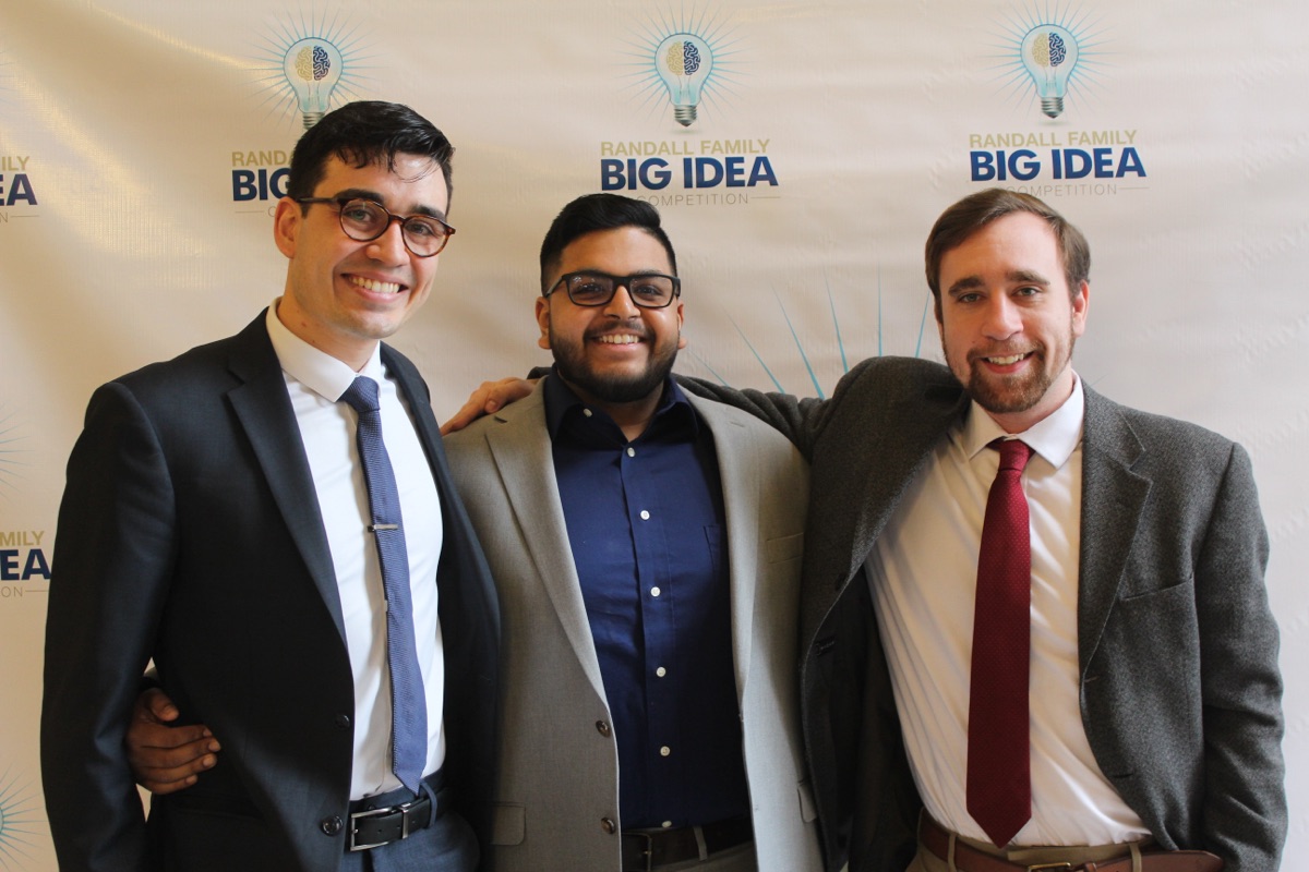 Three HEARTio cofounders in front of the Randall Family Big Idea Competition backdrop